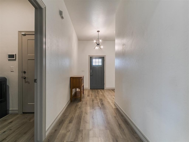 11021 SW 35th Ter, Yukon, OK 73099 - hall featuring a chandelier, wood finished floors, and baseboards