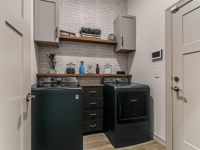 11021 SW 35th Ter, Yukon, OK 73099 - laundry room with washer and dryer, light wood-style floors, and cabinet space