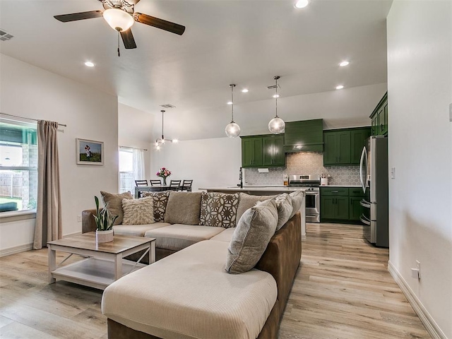 11021 SW 35th Ter, Yukon, OK 73099 - living area with light wood finished floors, lofted ceiling, ceiling fan, recessed lighting, and baseboards