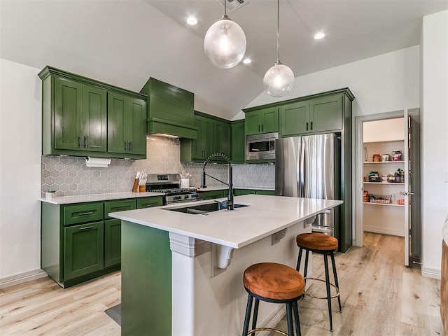 11021 SW 35th Ter, Yukon, OK 73099 - kitchen with stainless steel appliances, green cabinetry, a sink, light wood-type flooring, and vaulted ceiling
