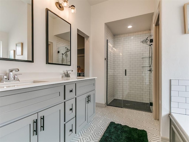 11021 SW 35th Ter, Yukon, OK 73099 - bathroom featuring a stall shower, double vanity, a spacious closet, and tile patterned floors