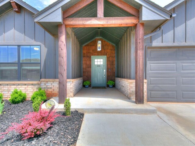 11021 SW 35th Ter, Yukon, OK 73099 - entrance to property with board and batten siding, an attached garage, and driveway