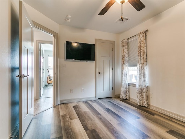 11021 SW 35th Ter, Yukon, OK 73099 - unfurnished bedroom featuring light wood finished floors, baseboards, and ceiling fan