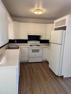 117 Phillips Ln, Clinton, OK 73601 - kitchen with white appliances, a sink, under cabinet range hood, light countertops, and white cabinetry