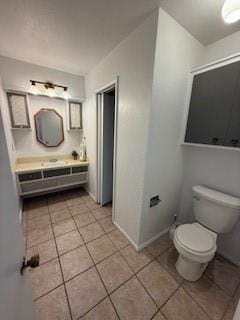 117 Phillips Ln, Clinton, OK 73601 - bathroom with tile patterned floors, toilet, baseboards, and vanity