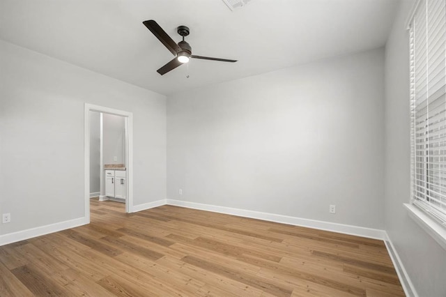 unfurnished room featuring ceiling fan, baseboards, and light wood-style floors