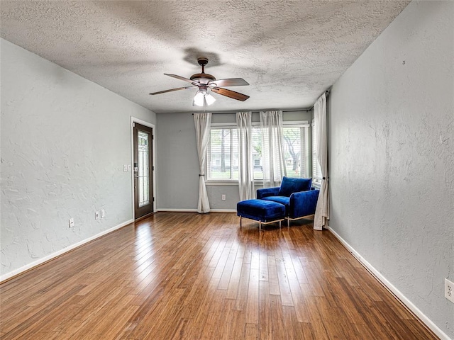 2429 Barclay Rd, Oklahoma City, OK 73120 - living area featuring a textured wall, a textured ceiling, ceiling fan, and hardwood / wood-style floors