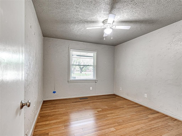 2429 Barclay Rd, Oklahoma City, OK 73120 - empty room featuring light wood finished floors, ceiling fan, a textured ceiling, and a textured wall