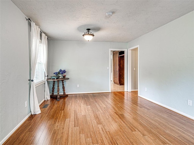 2429 Barclay Rd, Oklahoma City, OK 73120 - empty room featuring a smoke detector, light wood-style floors, and a textured ceiling