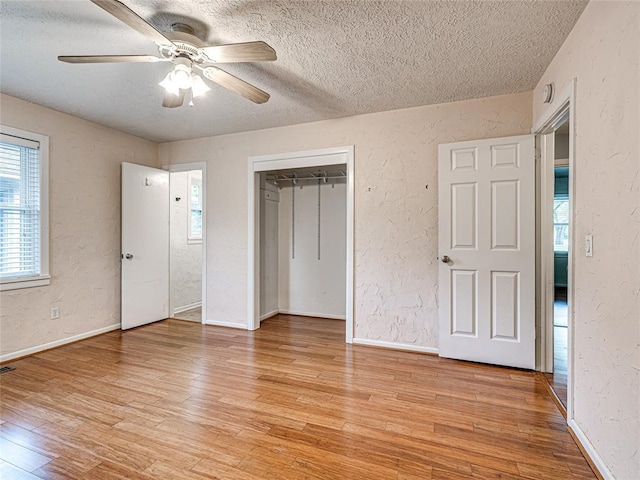 2429 Barclay Rd, Oklahoma City, OK 73120 - unfurnished bedroom featuring a textured ceiling, a textured wall, light wood-style floors, a closet, and ceiling fan