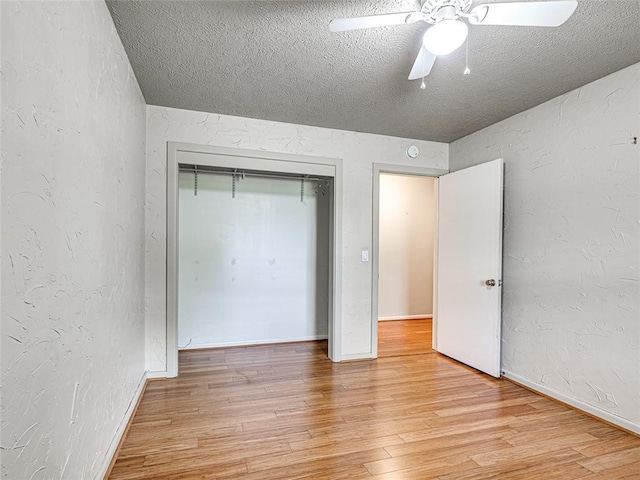 2429 Barclay Rd, Oklahoma City, OK 73120 - unfurnished bedroom featuring light wood-style flooring, a textured ceiling, a textured wall, a ceiling fan, and a closet