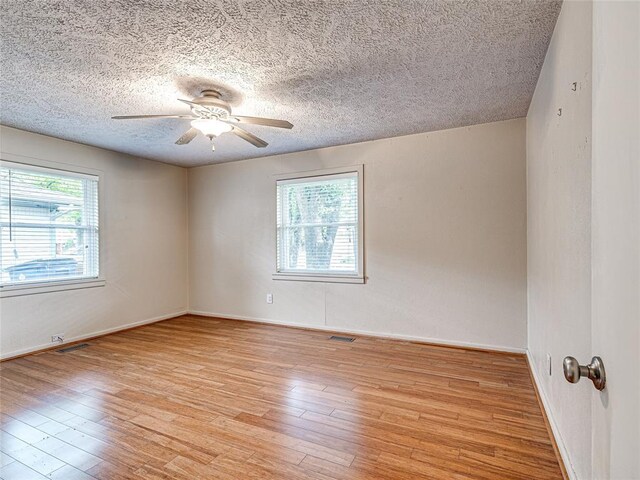2429 Barclay Rd, Oklahoma City, OK 73120 - unfurnished room with a textured ceiling, light wood-style floors, and ceiling fan