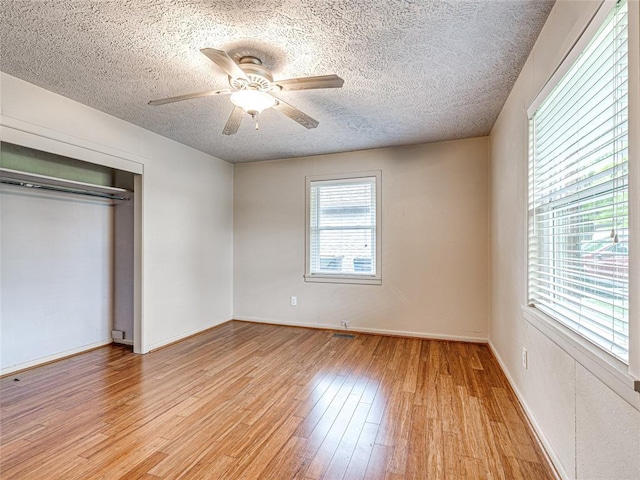 2429 Barclay Rd, Oklahoma City, OK 73120 - unfurnished bedroom featuring a textured ceiling, light wood-type flooring, a closet, and a ceiling fan