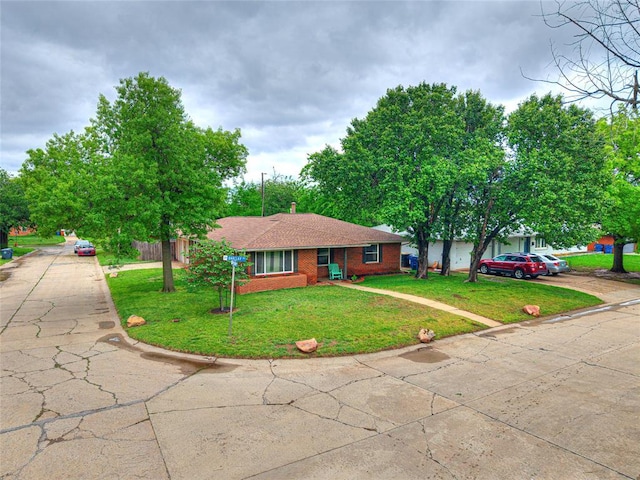 2429 Barclay Rd, Oklahoma City, OK 73120 - single story home with concrete driveway, brick siding, and a front yard