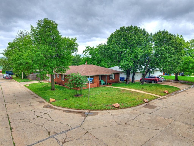 2429 Barclay Rd, Oklahoma City, OK 73120 - ranch-style home featuring driveway, brick siding, and a front lawn
