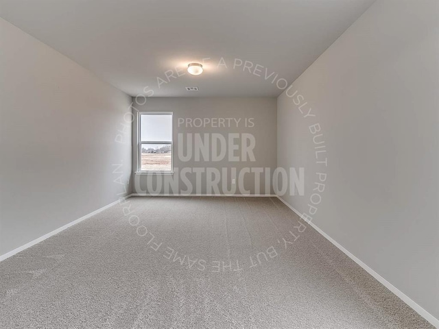 carpeted empty room with baseboards and visible vents