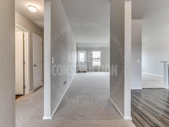 hall with baseboards and carpet floors