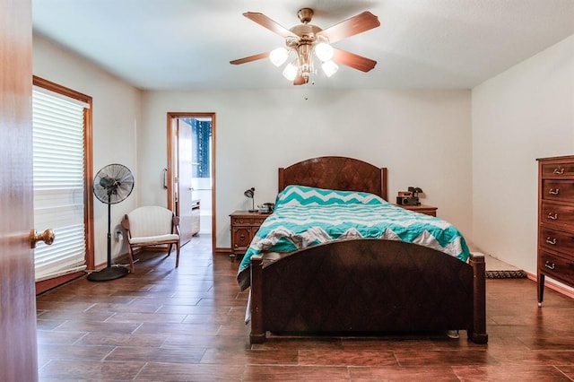 bedroom with baseboards, a ceiling fan, and dark wood-style floors