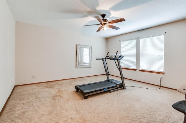 exercise area with carpet floors, baseboards, and a healthy amount of sunlight