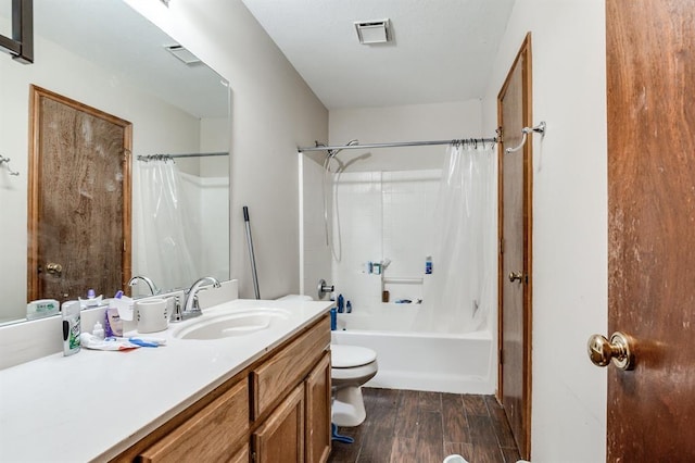 bathroom with visible vents, wood finished floors, vanity, toilet, and shower / tub combo with curtain