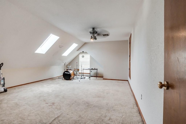 bonus room with visible vents, carpet, and vaulted ceiling with skylight