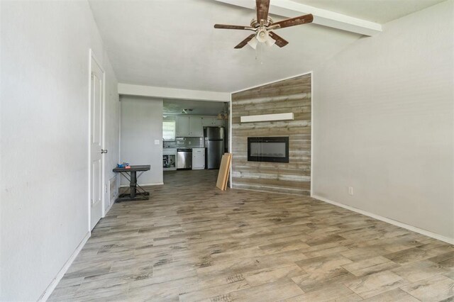 1662 NE 6th St, Moore, OK 73160 - unfurnished living room with ceiling fan, a glass covered fireplace, light wood-style flooring, and baseboards