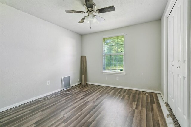 1662 NE 6th St, Moore, OK 73160 - unfurnished bedroom featuring wood finished floors, a closet, baseboards, and a ceiling fan