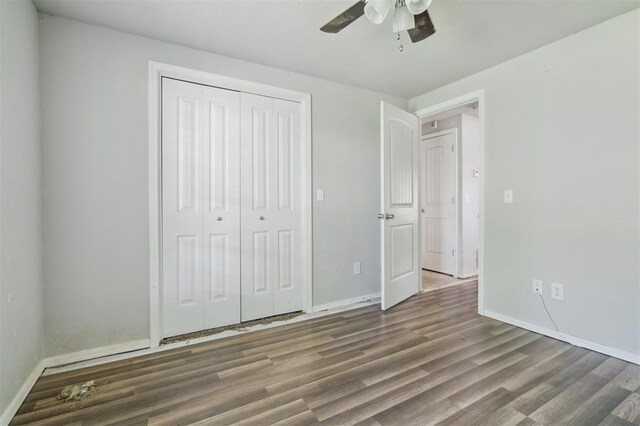 1662 NE 6th St, Moore, OK 73160 - unfurnished bedroom featuring wood finished floors, baseboards, a closet, and ceiling fan