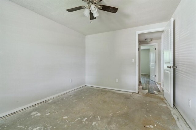 1662 NE 6th St, Moore, OK 73160 - spare room featuring ceiling fan, baseboards, and concrete flooring