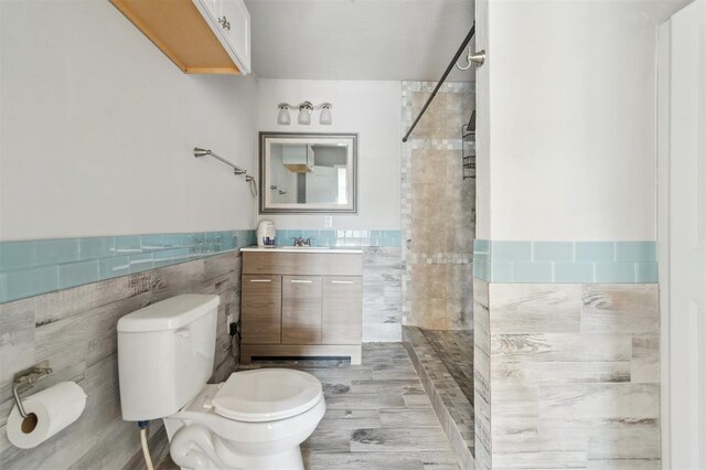 1662 NE 6th St, Moore, OK 73160 - full bath featuring tile walls, toilet, tiled shower, a wainscoted wall, and vanity