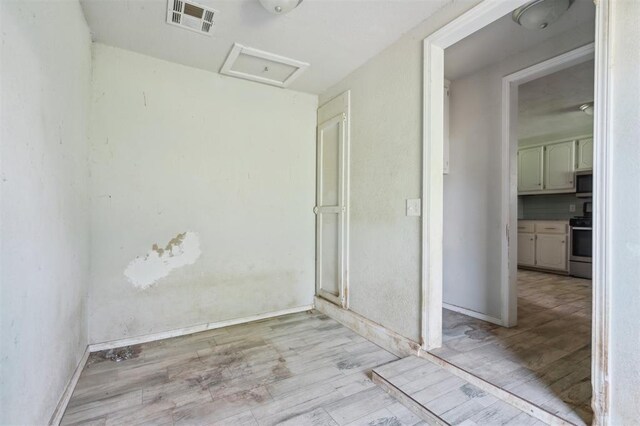 1662 NE 6th St, Moore, OK 73160 - spare room with attic access, light wood finished floors, and baseboards