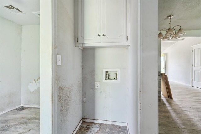 1662 NE 6th St, Moore, OK 73160 - clothes washing area with a chandelier, washer hookup, wood finished floors, and cabinet space