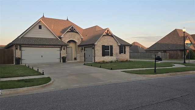 18812 Trailview Way, Edmond, OK 73012 - french country inspired facade with fence, driveway, a shingled roof, an attached garage, and a yard