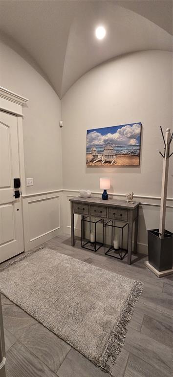 18812 Trailview Way, Edmond, OK 73012 - office space with vaulted ceiling, wainscoting, and a decorative wall