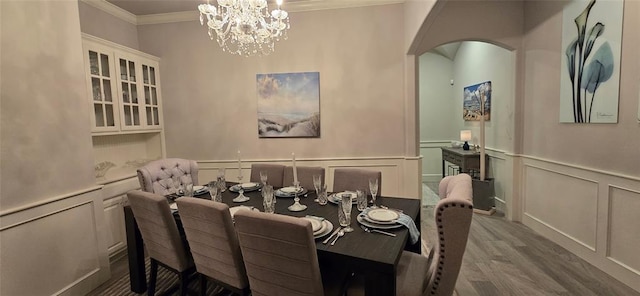 18812 Trailview Way, Edmond, OK 73012 - dining room featuring an inviting chandelier, arched walkways, ornamental molding, and a decorative wall