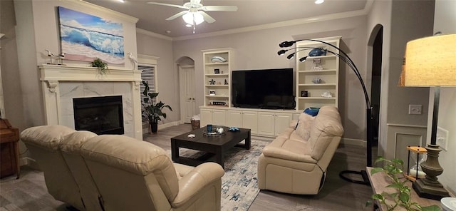 18812 Trailview Way, Edmond, OK 73012 - living area featuring a premium fireplace, a ceiling fan, ornamental molding, and wood finished floors