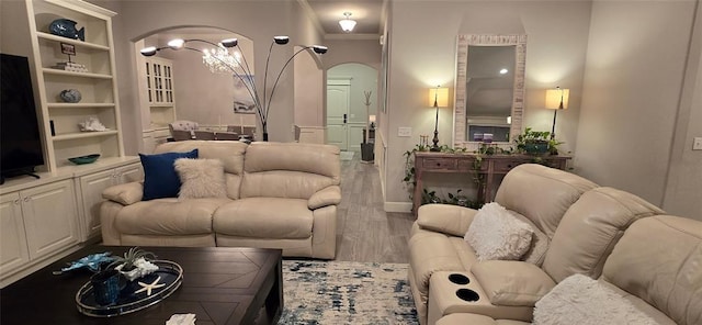 18812 Trailview Way, Edmond, OK 73012 - living area featuring arched walkways, wood finished floors, and a notable chandelier