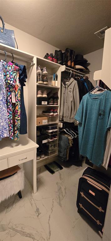18812 Trailview Way, Edmond, OK 73012 - walk in closet featuring visible vents and marble finish floor
