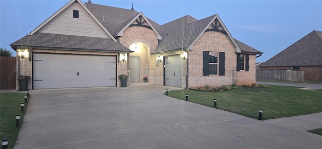 18812 Trailview Way, Edmond, OK 73012 - view of front of house featuring a front lawn, brick siding, a shingled roof, an attached garage, and driveway