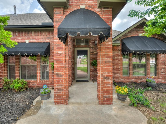 10812 S Miller Ave, Oklahoma City, OK 73170 - view of exterior entry featuring brick siding and roof with shingles