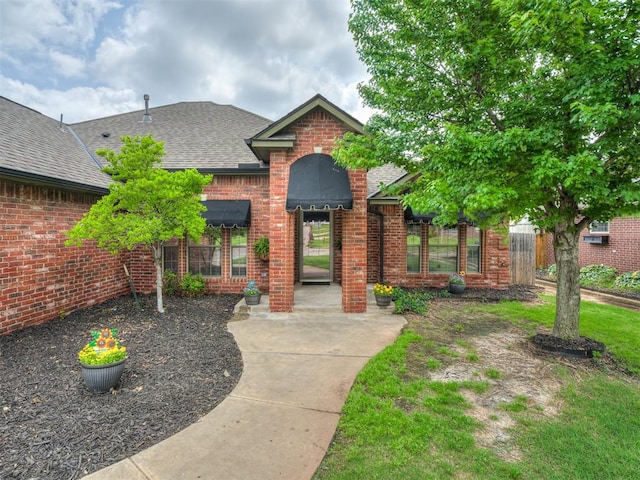 10812 S Miller Ave, Oklahoma City, OK 73170 - view of front of home featuring brick siding and roof with shingles