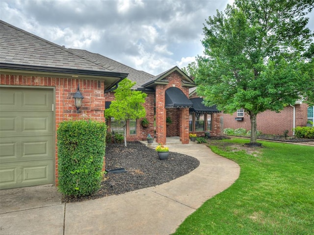 10812 S Miller Ave, Oklahoma City, OK 73170 - entrance to property with roof with shingles, brick siding, and a lawn