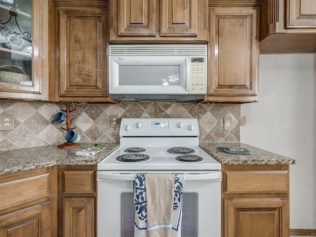 10812 S Miller Ave, Oklahoma City, OK 73170 - kitchen featuring white appliances, tasteful backsplash, brown cabinetry, and light stone countertops