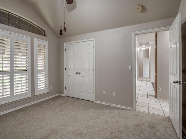 10812 S Miller Ave, Oklahoma City, OK 73170 - unfurnished bedroom featuring light colored carpet, lofted ceiling, baseboards, light tile patterned floors, and ceiling fan