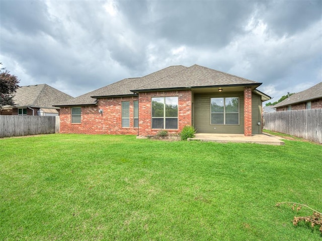 10812 S Miller Ave, Oklahoma City, OK 73170 - back of house featuring roof with shingles, brick siding, and a patio area