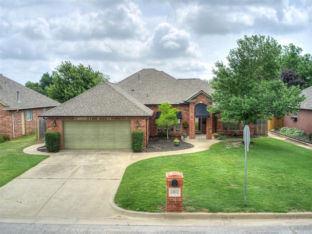 10812 S Miller Ave, Oklahoma City, OK 73170 - traditional-style house featuring roof with shingles, a garage, concrete driveway, and brick siding
