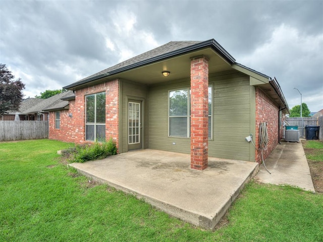 10812 S Miller Ave, Oklahoma City, OK 73170 - back of house featuring a patio area, brick siding, roof with shingles, and central AC unit