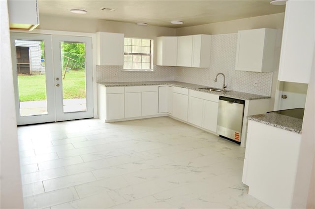 kitchen with a sink, french doors, marble finish floor, decorative backsplash, and stainless steel dishwasher