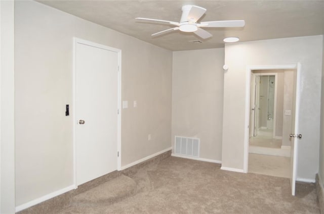 unfurnished bedroom with carpet floors, ceiling fan, visible vents, and baseboards