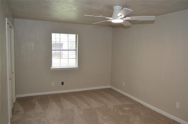 carpeted empty room with baseboards and ceiling fan
